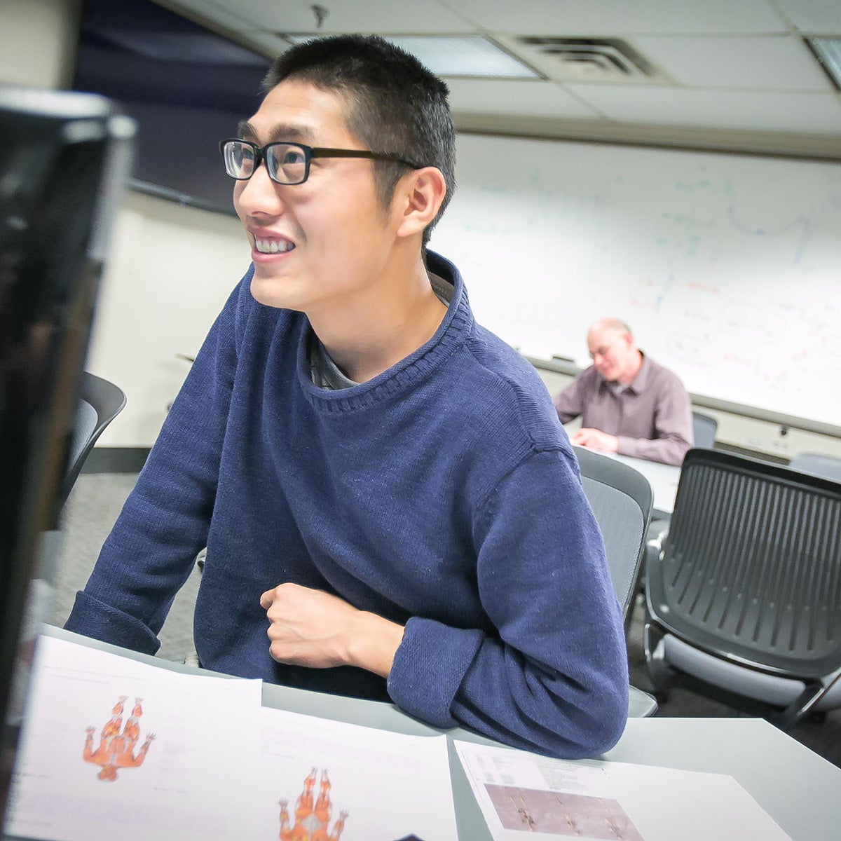 Photo of graduate student using a computer